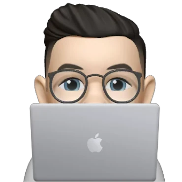 Memoji of Luigi behind a MacBook